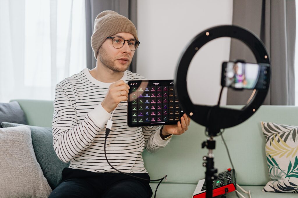 image of a content creator, holding a tablet device.
